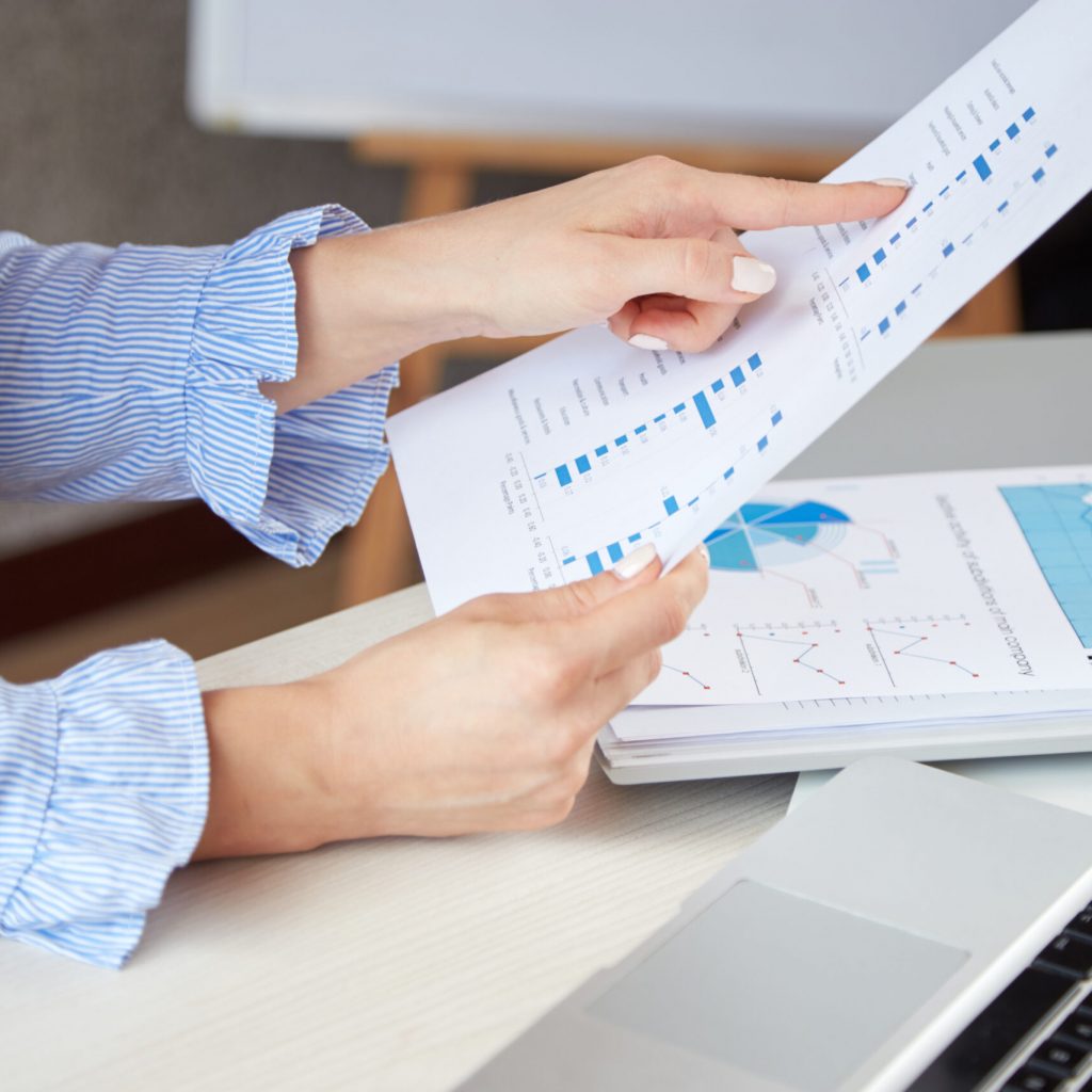 closeup-anonymous-woman-holding-sheet-paper-pointing-diagrams-it